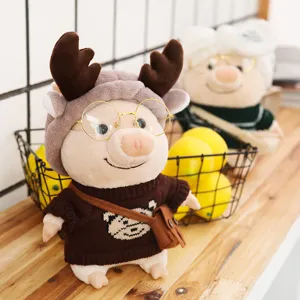 Detailed view of the cute plush pig toy wearing brown sweater and deer antler hat, cozy design.