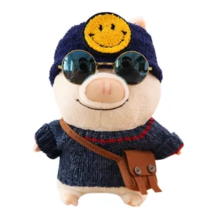 Cute plush pig toy with knitted sweater, blue hat, sunglasses and bag. Soft stuffed doll gift.