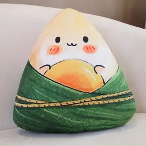 Cute cartoon zongzi plush pillow, soft triangle cushion with cute face and egg yolk design.