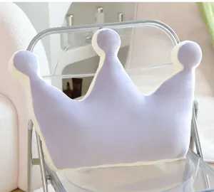 Close-up detail of the soft crown pillow texture and cozy home decor chair setup.