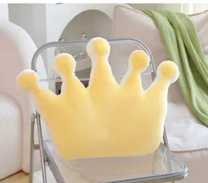 Close-up of the cute yellow crown plush pillow detailed texture and soft fabric interior.