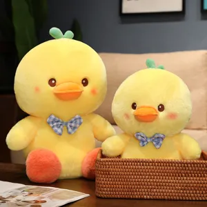 Cute yellow duck plush toy detail view, soft stuffed animal with blue plaid bowtie for kids.