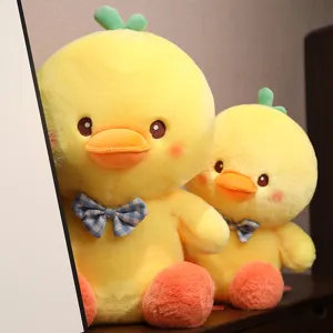 Cute plush yellow duck toy with sprout and blue plaid bow, soft stuffed doll gift for kids.