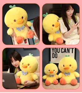 Cute yellow duck plush toy with blue bow tie and soft fabric, ideal gift for children.