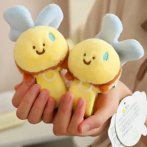 Cute plush bee slap bracelet detail shot, soft yellow toy with blue wings for kids fashion.