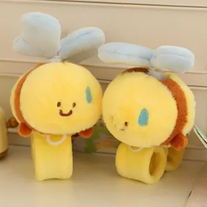 Cute plush bee slap bracelet detail view, showing soft yellow fabric, blue wings and embroidery.