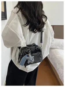 Dark denim Boston bag with shoulder strap, casual trendy commuter design with cute star charm.