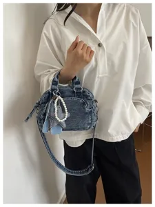 Detailed view of the stylish denim boston bag with pearl star charm, perfect for daily wear.