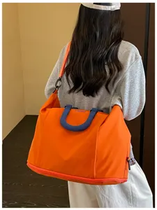 Large capacity solid color travel duffel bag, versatile casual shoulder bag for daily use.