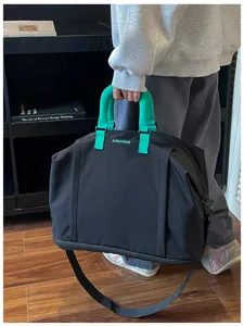 Large capacity travel duffel bag with green handles, stylish and portable for everyday use.