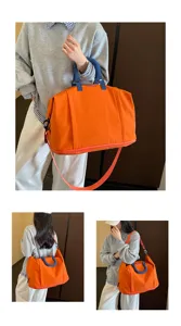 Large capacity travel duffel bag detail, orange and blue design, portable shoulder crossbody view.