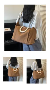 Large capacity solid color travel duffel shoulder bag with comfortable handles and strap details.