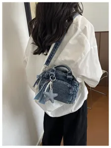 Denim Boston bag detail view, casual shoulder bag with star charm and pearl chain decoration.