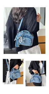 Detail view of the stylish denim Boston bag featuring a cute star pearl charm and versatile straps.