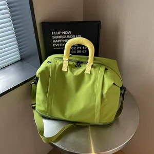 Large capacity solid color lightweight travel duffel bag with stylish bright yellow handles.