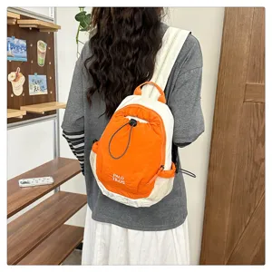 Outdoor contrast color backpack detail showing drawstring closure and side mesh pocket design.