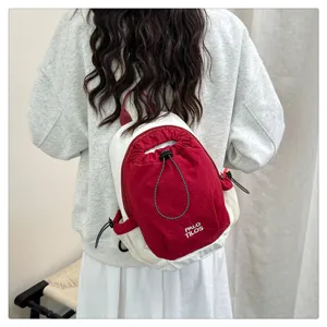 Color-blocked mini backpack with drawstring closure, casual lightweight outdoor travel daypack.