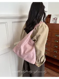 Pink suede shoulder bag for women, retro casual large capacity tote bag for daily commute.