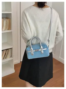Trendy light blue denim mini handbag with silver hardware and top handle for women stylish daily wear.