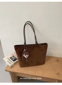 Brown suede tote bag detail, casual large capacity shoulder bag with cute bear pendant.