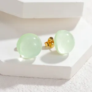 Detailed view of sweet candy color round stud earrings with gold tone backing and clear design.