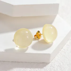 Close-up detail of sweet candy color round stud earrings, minimalist geometric design for women.