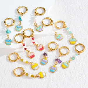 Detailed view of colorful dopamine cupcake dangle earrings with metal hoops and cute beads.