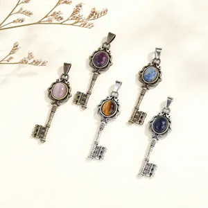 Vintage key pendant necklace with natural gemstone, palace style metal alloy jewelry detail.