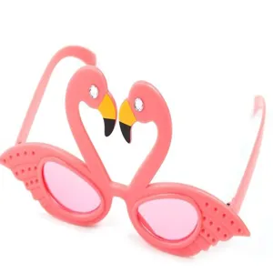 Pink flamingo shaped party sunglasses detail shot, great for summer beach holiday photo props.