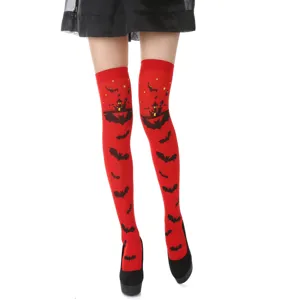 Detailed view of red over-the-knee socks featuring Halloween bat and castle patterns.