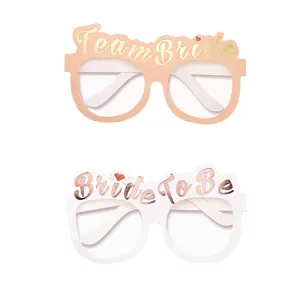 Detail view of paper party glasses with Team Bride and Bride to Be text, ideal for photo props.