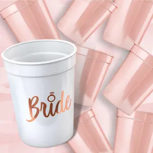 Bachelorette party plastic cups in pastel pink with team bride and bride text detail.