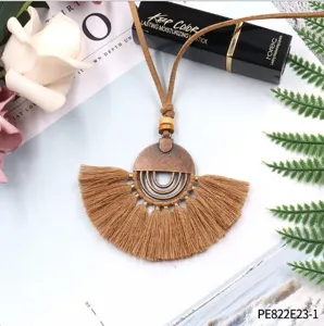 Vintage bohemian retro tassel necklace with bronze pendant and suede cord for women.