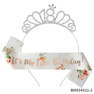 Detailed closeup of the sparkling rhinestone 18th birthday tiara crown and floral satin sash.