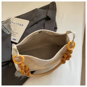 Detailed view of Chinese style fabric underarm shoulder bag with unique wooden bead handles.