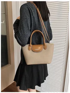 Minimalist canvas shoulder bag for women, stylish crossbody handbag with top handle and flap.