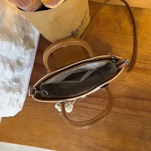 Stylish two-tone top handle crossbody bag for women, casual shoulder bag with spacious interior.