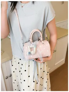 Pink polka dot barrel bag detail, cute musical note pendant, daily fashion shoulder bag.