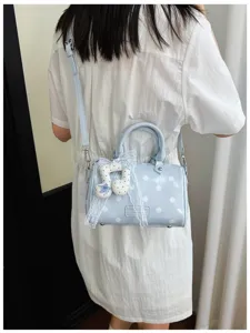 Chic polka dot barrel shoulder bag for women, stylish casual crossbody purse with cute pendant.