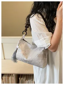 Chinese style brocade underarm shoulder bag with wooden bead handle and chic tassel charm.