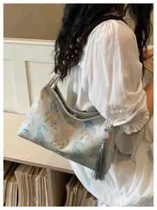 Chinese style vintage brocade shoulder bag with wooden bead strap and chic tassel detail.