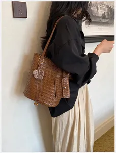 Brown woven leather tote bag for women, stylish shoulder handbag with small pouch.