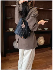 Woven shoulder tote bag for women, chic black leather daily commuting handbag with flower charm.