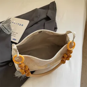 Stylish Chinese style shoulder bag for women, large capacity commuter tote with beaded handle.