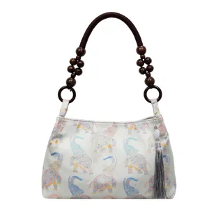 Chinese style vintage elephant pattern shoulder bag with wooden beaded handle and tassel pendant.