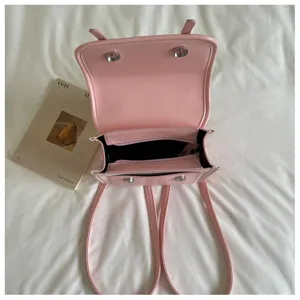Pink leather women backpack detail view, stylish casual student bookbag for daily commute and travel.