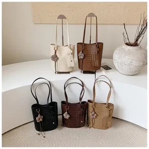 Woven tote bag for women, stylish shoulder commuter bag with matching pouch and chic charm.
