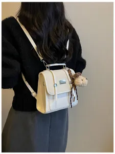 Detailed view of women small white backpack, college style casual daily commuter school bag.