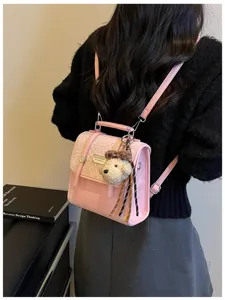 Pink college style backpack for women with cute bear pendant and chic leopard print flap design.