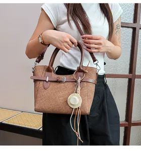 Vintage brown women crossbody handbag with handle strap and mini hat pendant for daily commuting.